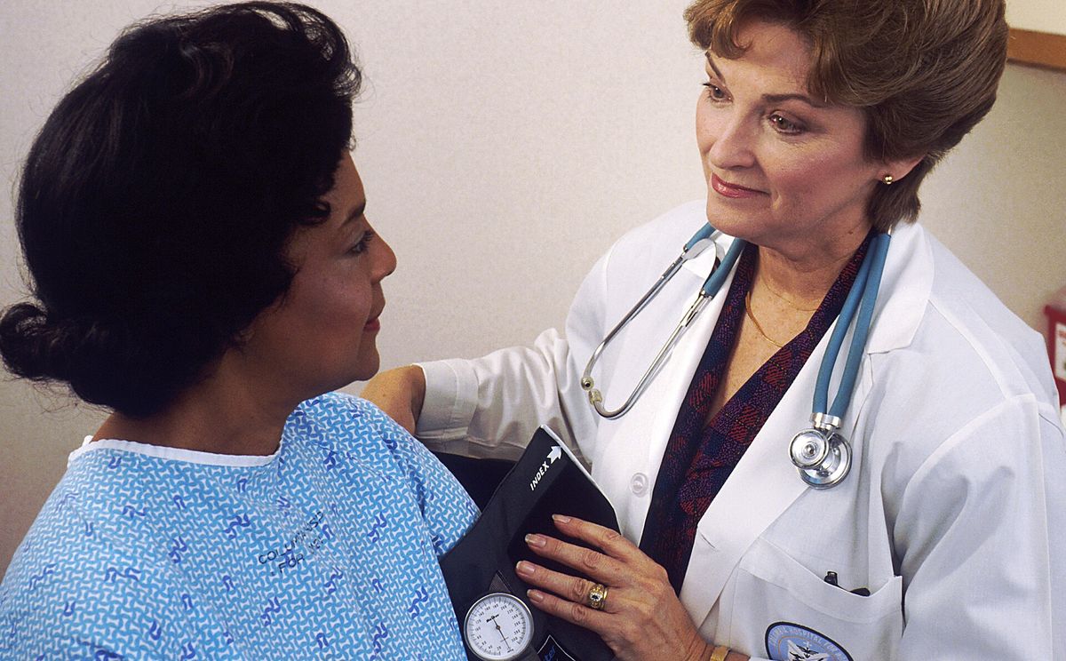 Doctor taking a patient's blood pressure
